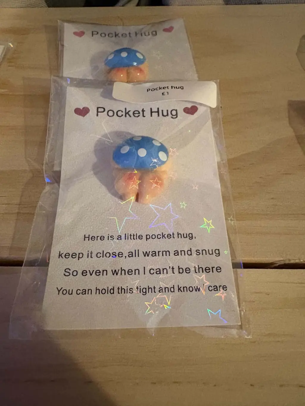 A blue spotty mushroom charm on a Pocket Hug card with a short verse